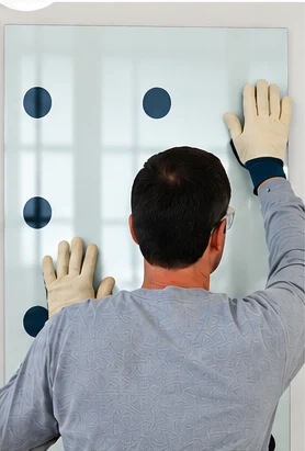 Installer pressing glass firmly into position
